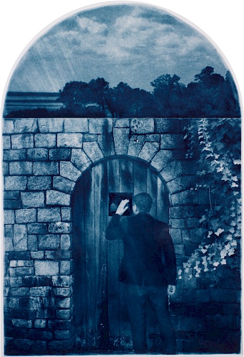 man in front of locked gate and he peers through a peep hole to the landscape beyond