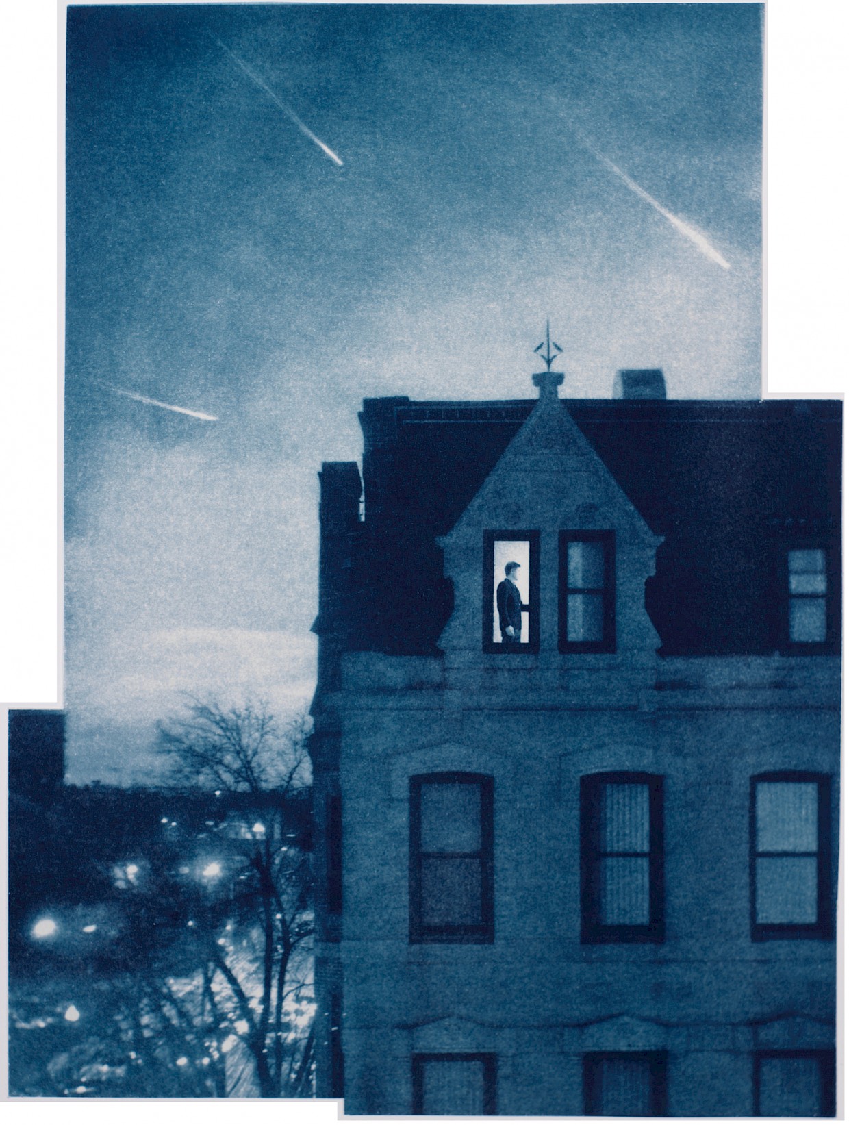 man seen through window of row house against backdrop of light streaks in evening sky