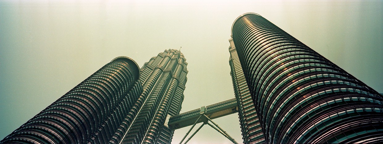 Soaring metal towers of Petronas Twin Towers Malaysia shot from below