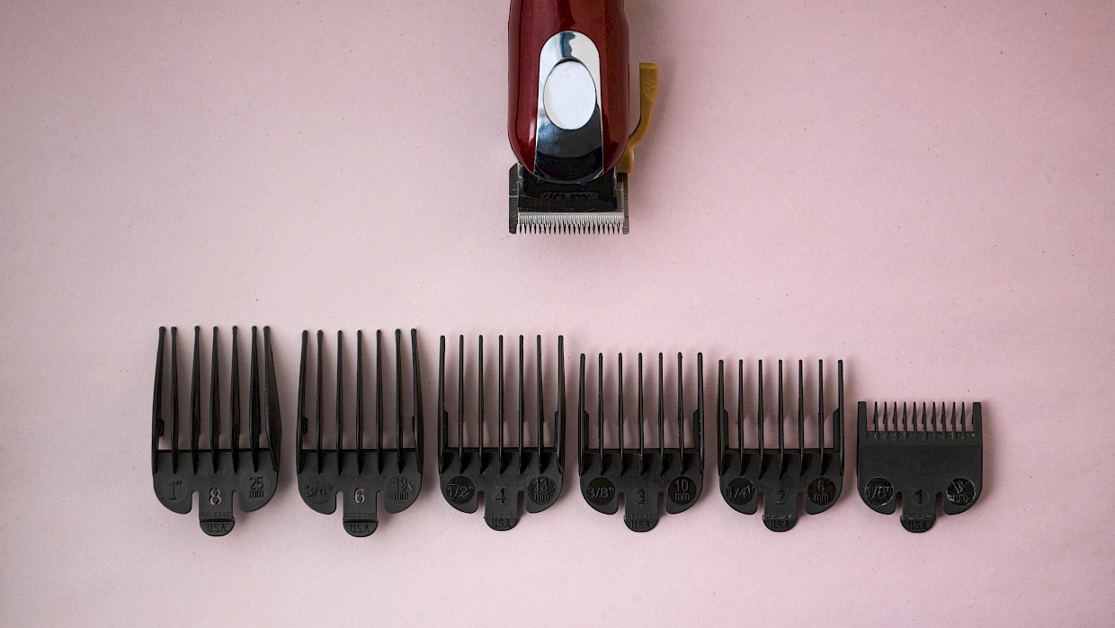 still life of hair clipper and size attachments